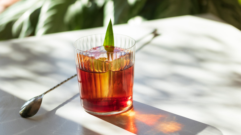 Barspoon and drink on table