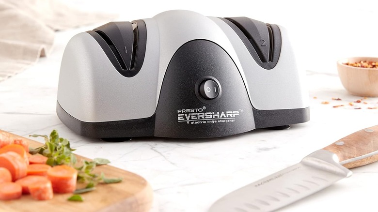 A knife in front of a Presto EverSharp Electric Knife Sharpener