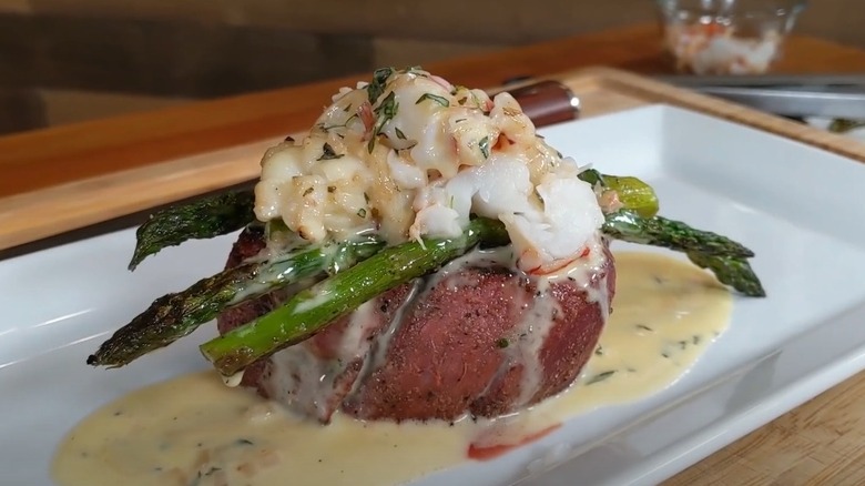 Filet mignon steak topped with crab, asparagus, and Bearnaise sauce