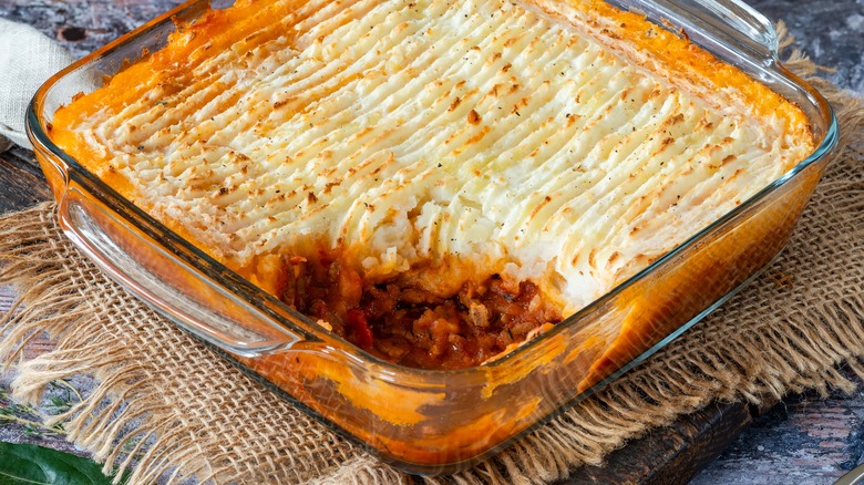 Shepherd's pie in glass oven rectangular dish on a rattan textile
