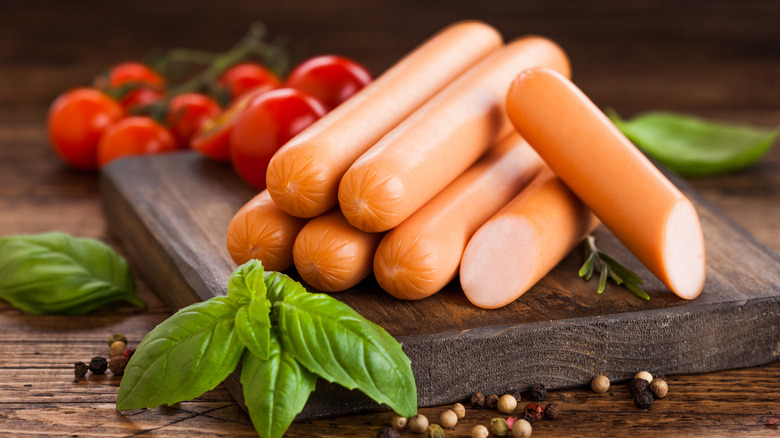 Hot dogs on wooden board