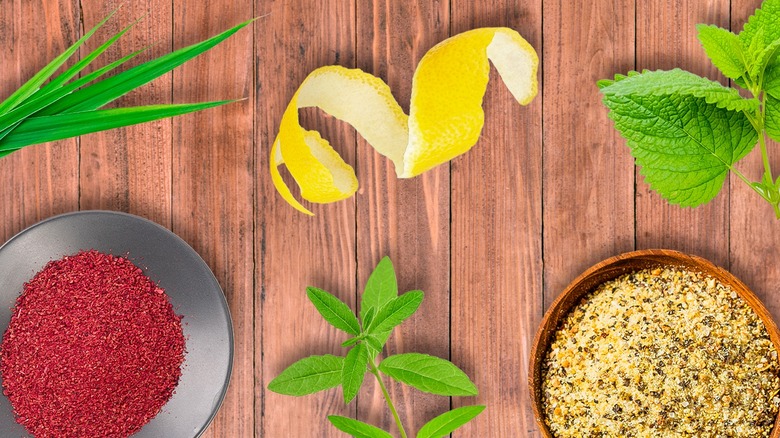 Lemon zest surrounded by various substitute ingredients on a wooden table