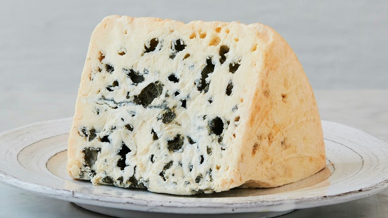 A wedge of Roquefort on a saucer