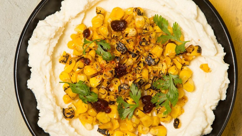A bowl of soft white cheese with corn