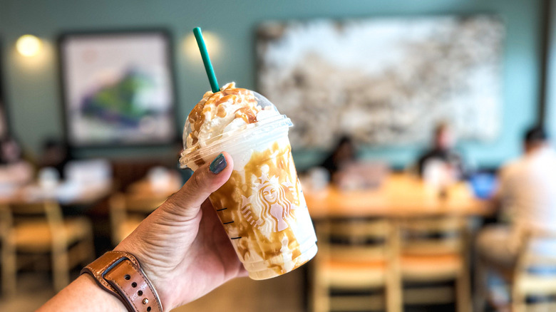 Hand holding a Butterbeer Frappuccino
