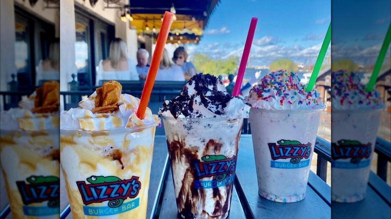 Line up of three Milkshakes on an outdoor table from Lizzy's