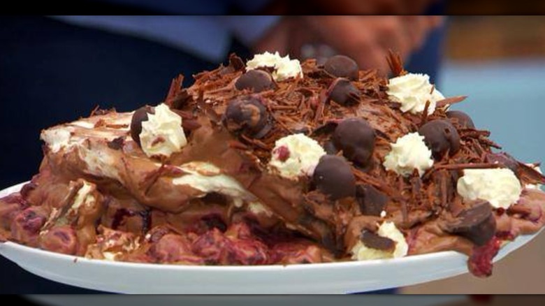 A melted black forest gateau on a white plate