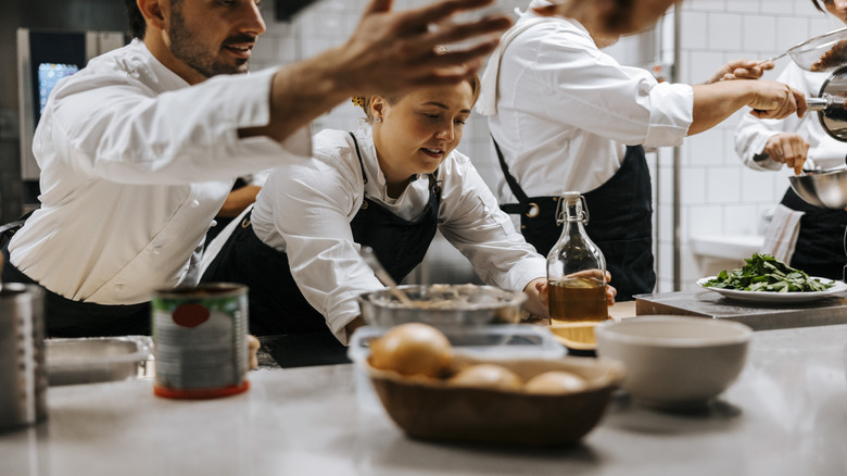 Cooks busily working around each other