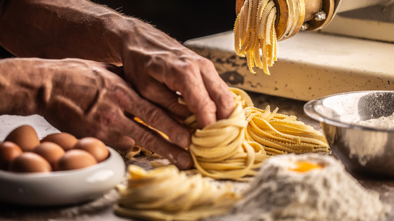 Shaped raw pasta coming out of machine