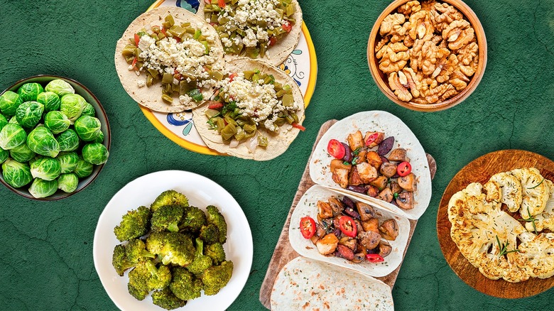 Vegetarian tacos surrounded by various filling ingredients against a green background