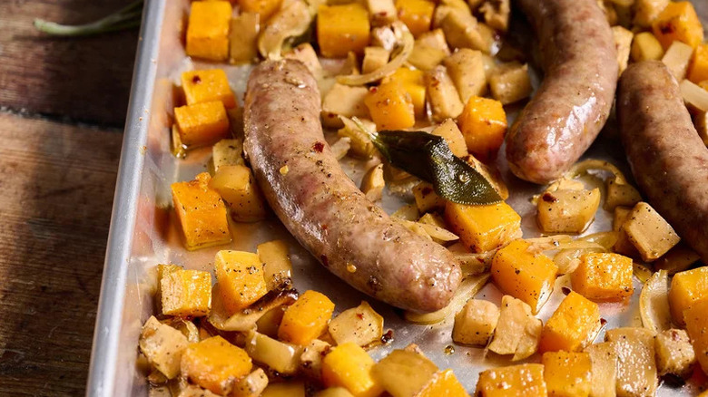 Mustardy Sheet Pan Sausage and Apples with pan on wooden table