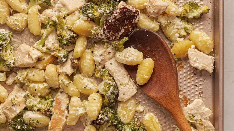 Sheet Pan Gnocchi with Chicken and Broccoli with wooden spoon