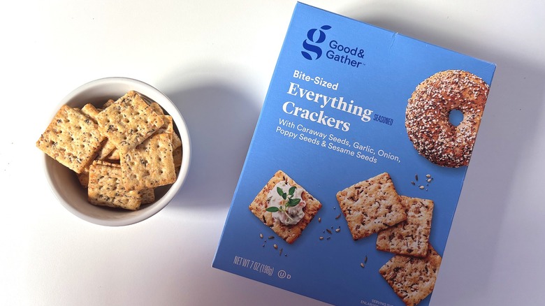 Box of Good & Gather Bite-Sized Everything Crackers next to a small white bowl of crackers on a white table
