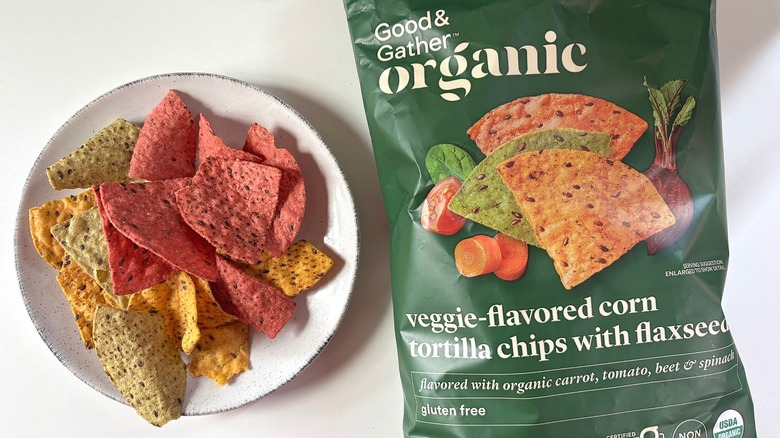 Bag of Good & Gather Organic Veggie-Flavored Corn Tortilla Flaxseed Chips next to a white plate of chips on a white table
