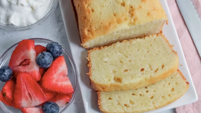 Sliced pound cake on a platter with fresh berries