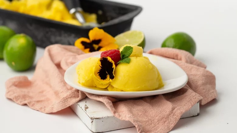 Mango sorbe on a plate with napkin