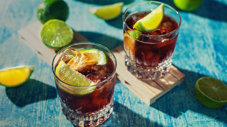 Two rum cocktails with limes