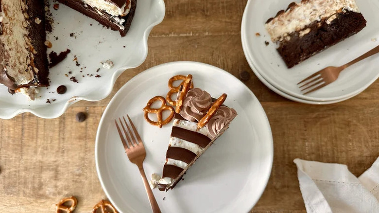 Chocolate covered pretzel ice cream cake on white plate