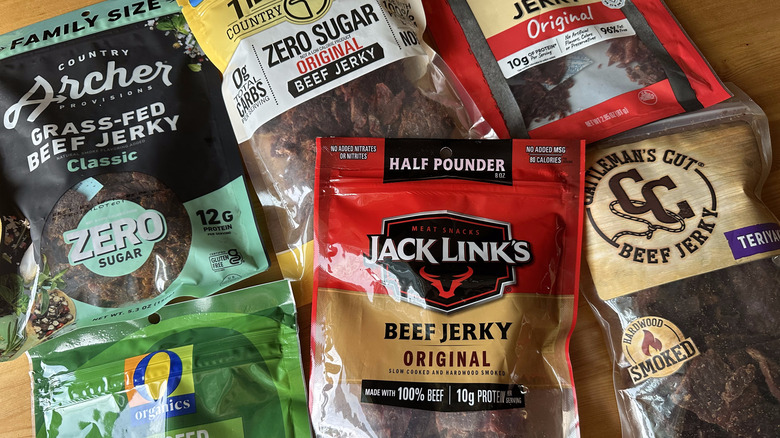 Beef jerky bags arranged on wooden table