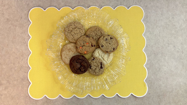 Various Betty Crocker cookies on clear platter on yellow placemat