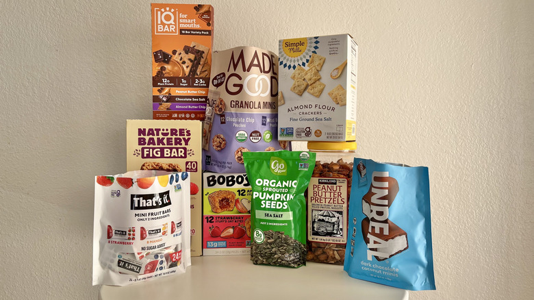 Various vegan snack packaging from Costco in front of a white wall