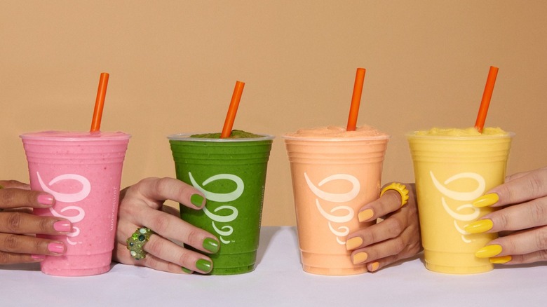hands holding Jamba smoothies in different flavors