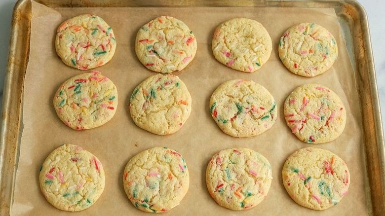 Rainbow sprinkle cookies on baking sheet