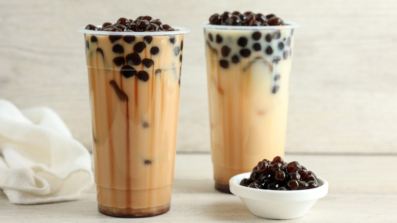 glasses of bubble tea and a bowl of boba