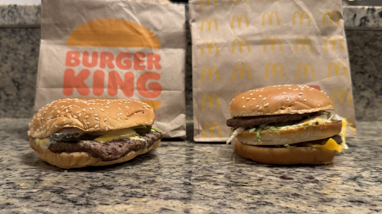 Whopper and Big Mac displayed with bags on counter