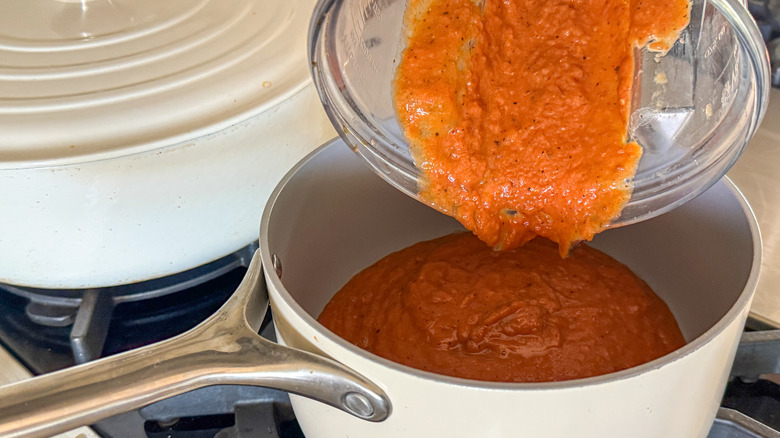 pouring soup into pot