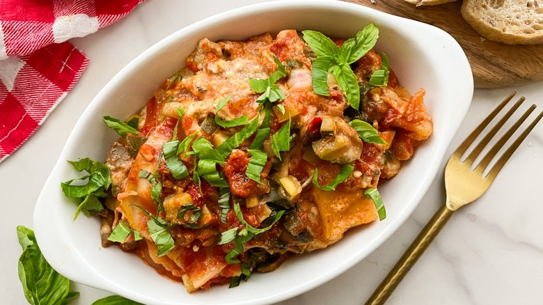 lasagna in white oval bowl