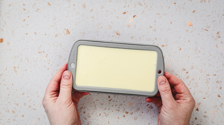 Hands holding small tray of lemon gelato