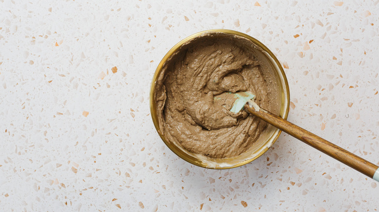 Chicken mousse in bowl with spatula