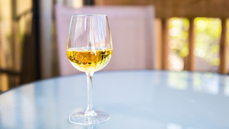 Apple cider in a wine glass on a table