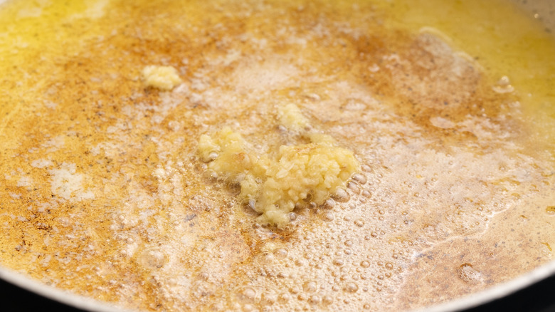 Crushed garlic cooking in pan