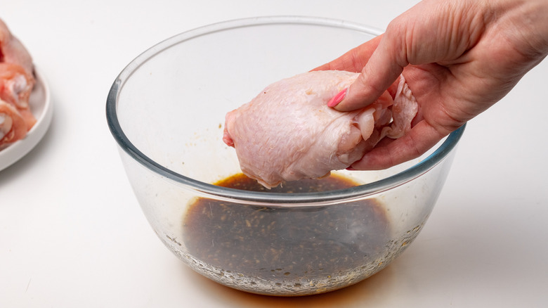 Placing chicken in a marinade