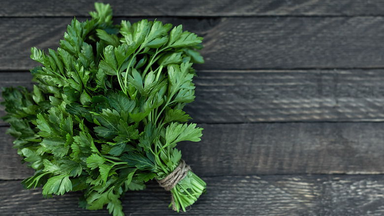 Bundled parsley on wood
