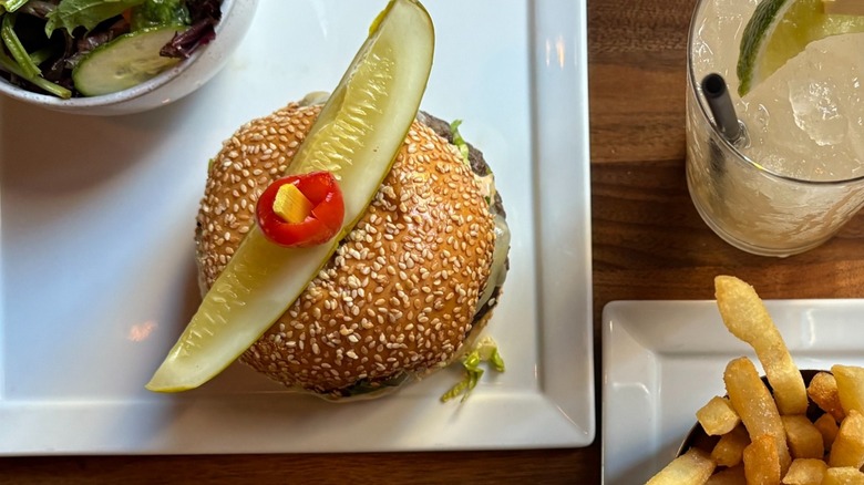 A cheeseburger with salad and fries