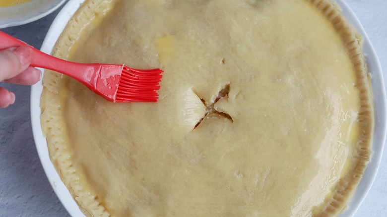 brushing egg wash on crust