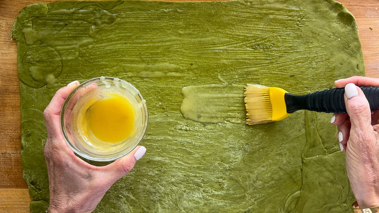 hand brushing on the butter