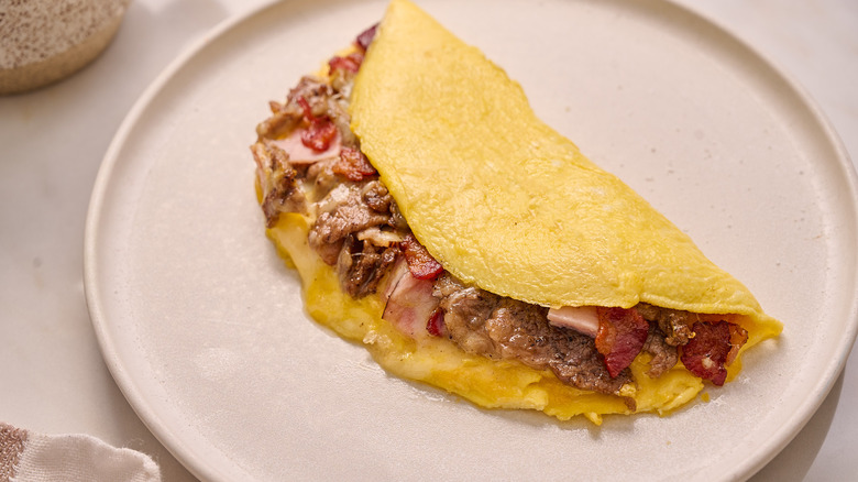 meat lovers omelette on plate