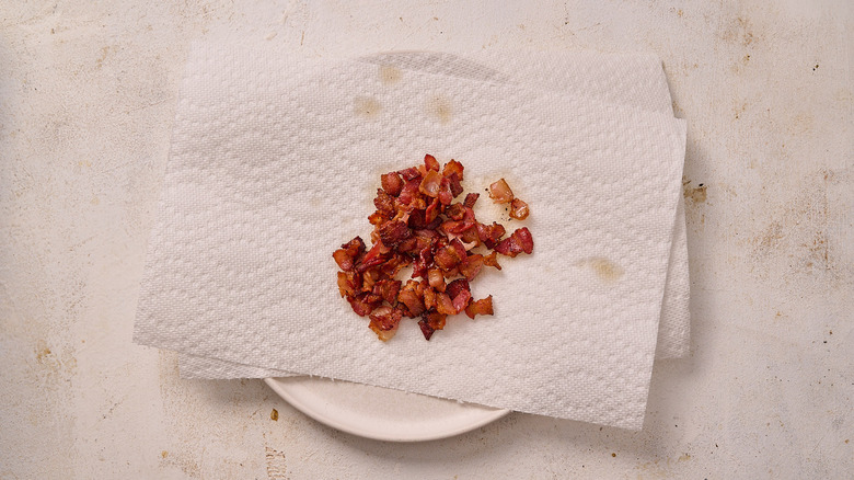 draining cooked bacon on paper towel