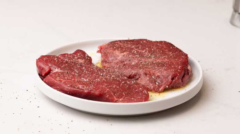 steaks with oil an seasonings
