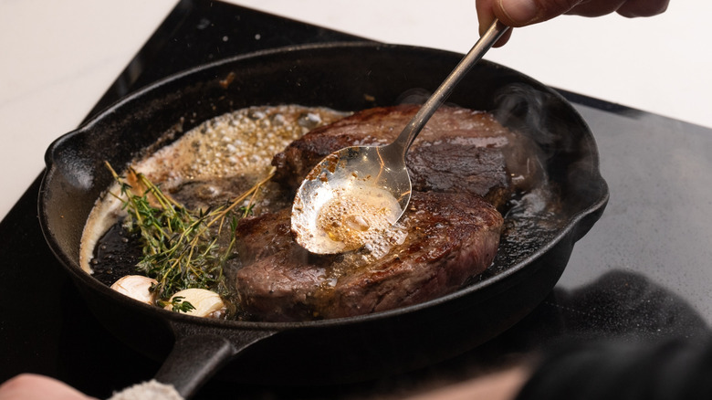 Basting steaks with pan juices