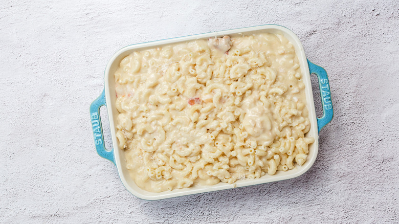 Casserole dish with unbaked mac and cheese