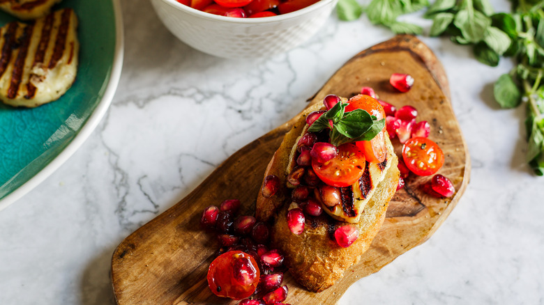 crostini on small board with ingredients in back