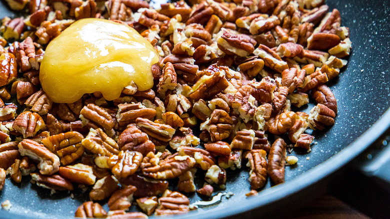 pecans in a saucepan with honey