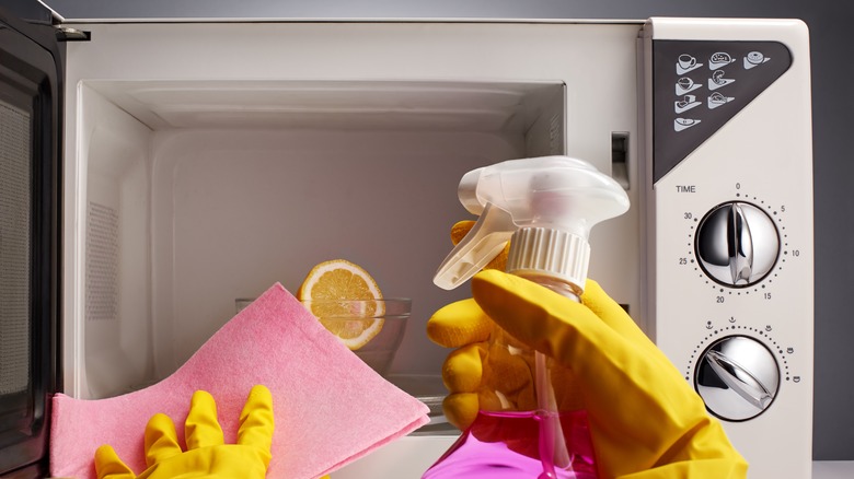 Cleaning microwave with spray and cloths