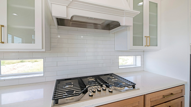 Kitchen stove and white tiled backsplash