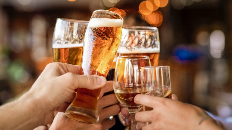 toasting glasses of beer